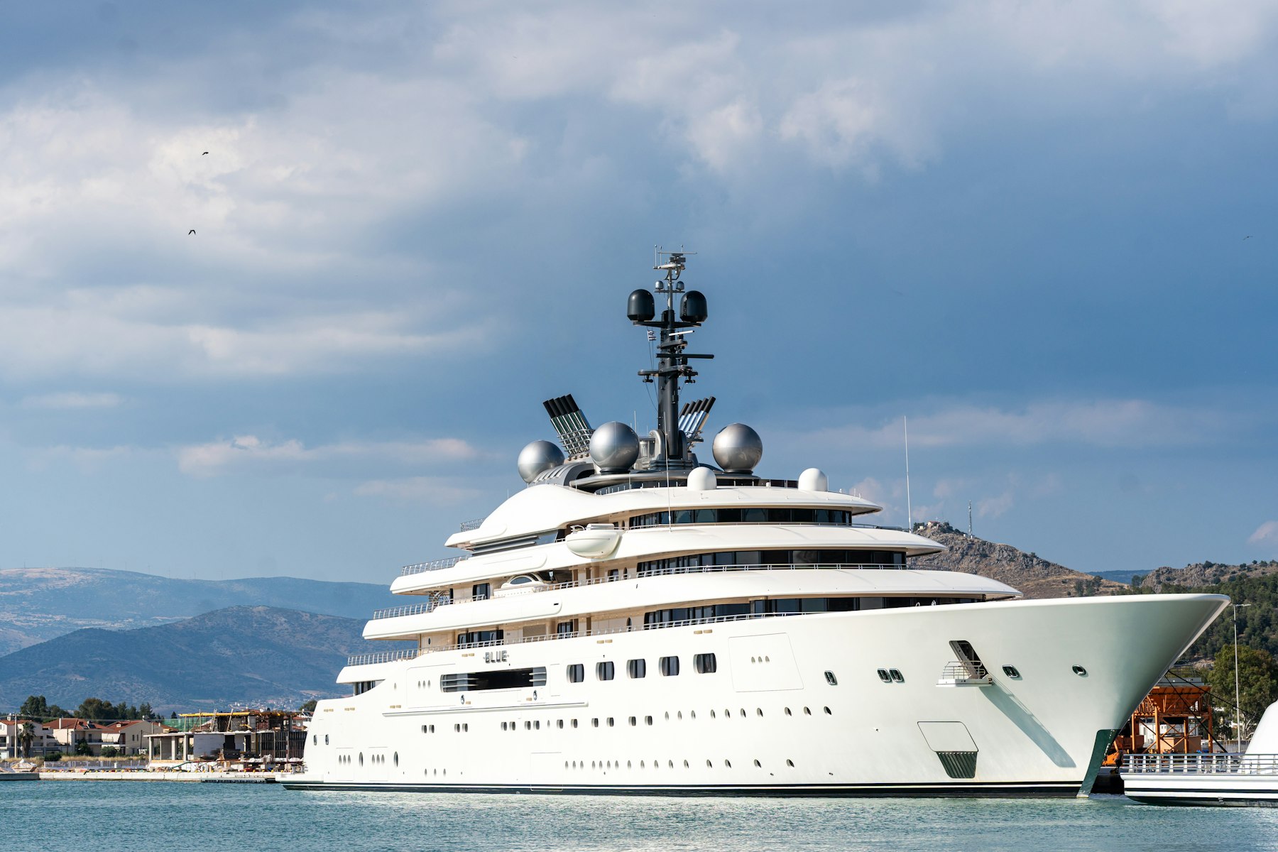 A large motor yacht at anchor in a calm bay